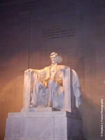 Lincoln Statue (angle view with text on wall above) at night